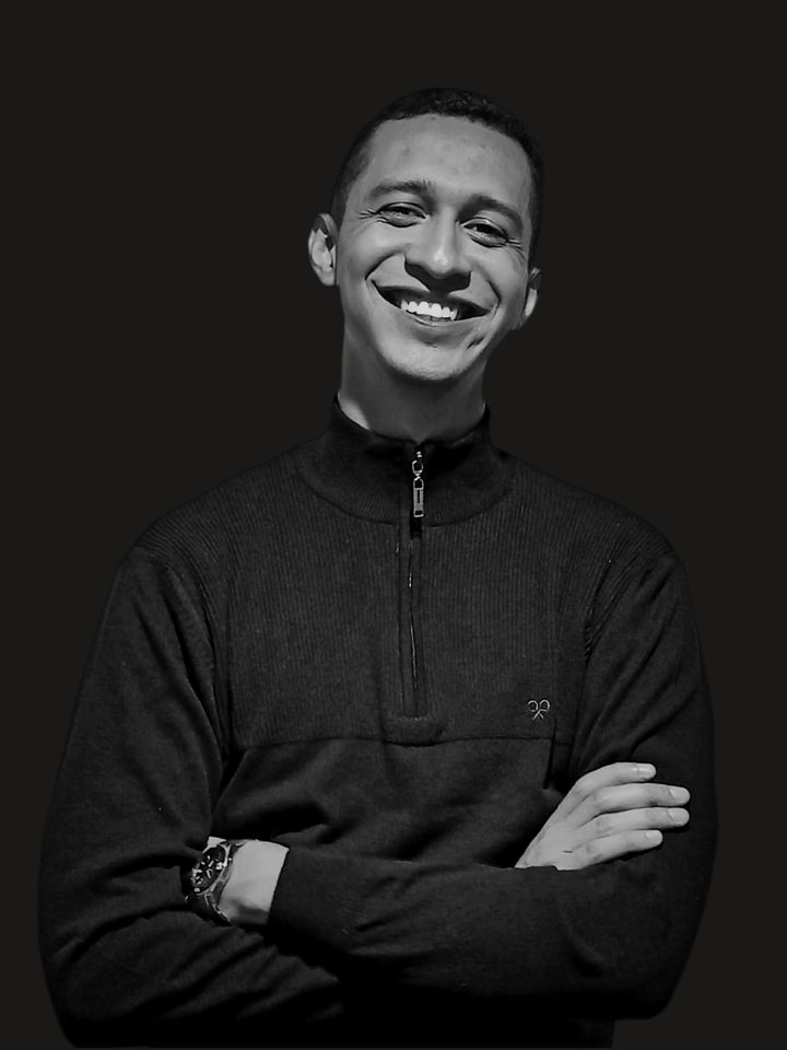 Jesús Valenzuela smiling with his arms crossed
